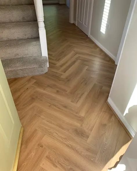 Herringbone laminate flooring installation. Photo 2 of 5.