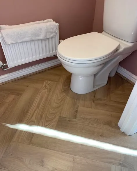 Herringbone laminate flooring installation. Photo 3 of 5.