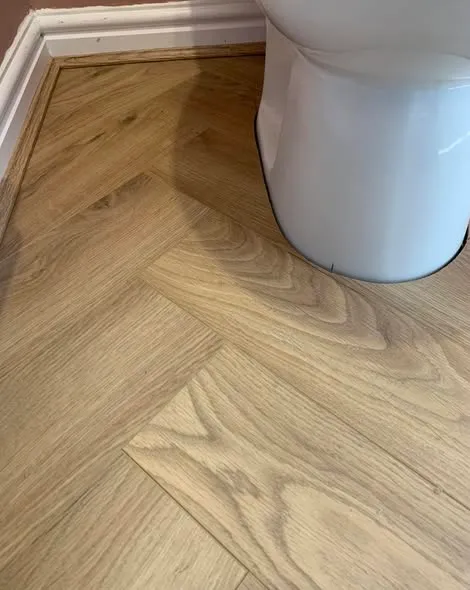 Herringbone laminate flooring installation. Photo 4 of 5.