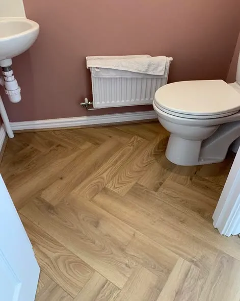 Herringbone laminate flooring installation. Photo 5 of 5.
