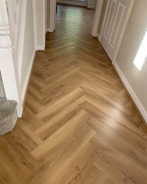 Herringbone laminate flooring installation. Photo 1 of 5.