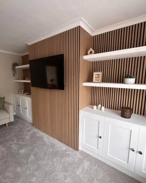 Media wall with timber slats, shelving and white storage cupboards. Photo 2 of 3.