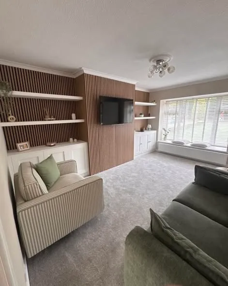 Media wall with timber slats, shelving and white storage cupboards. Photo 3 of 3.