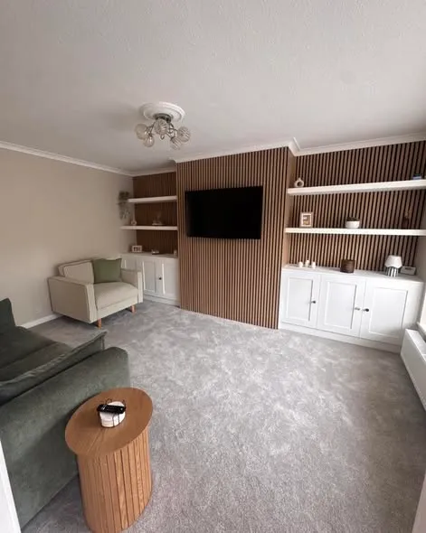Media wall with timber slats, shelving and white storage cupboards. Photo 1 of 3.
