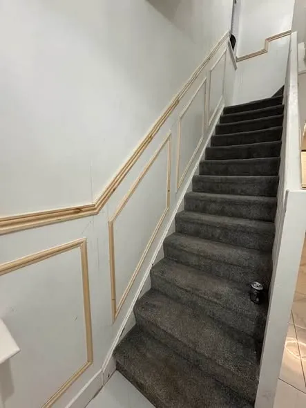 Wall panelling along a hallway and staircase. Photo 4 of 5.