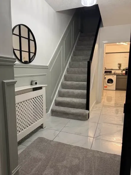 Wall panelling along a hallway and staircase. Photo 1 of 5.